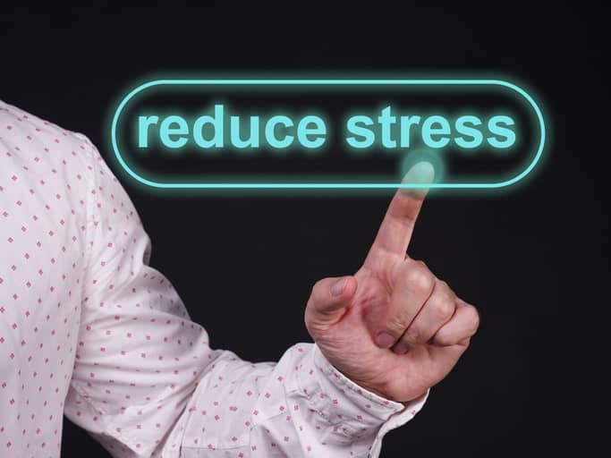 Man clicking virtual on-screen Reduce Stress button.